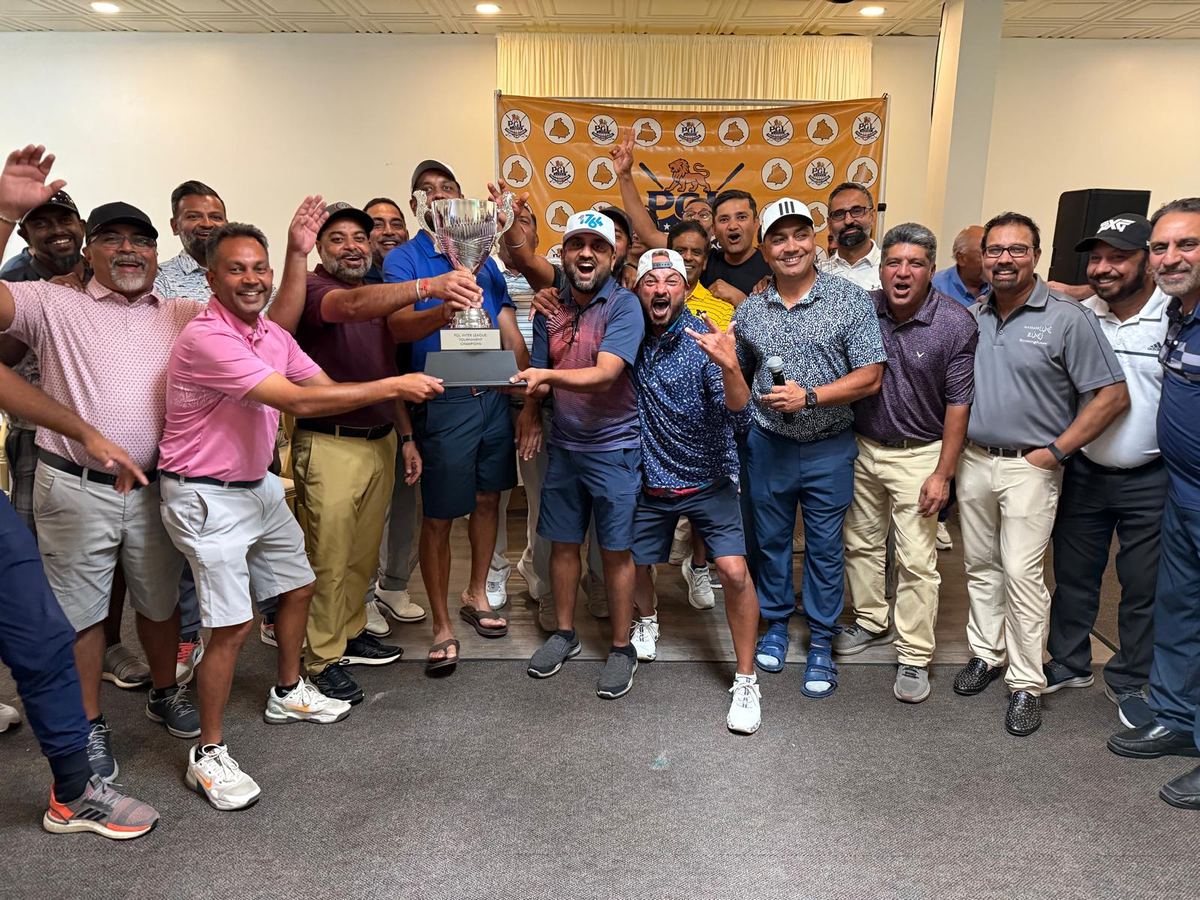 The BMS league crowded together holding the PGL Inter-League Championship Cup aloft in front of the Punjabi Golf League backdrop