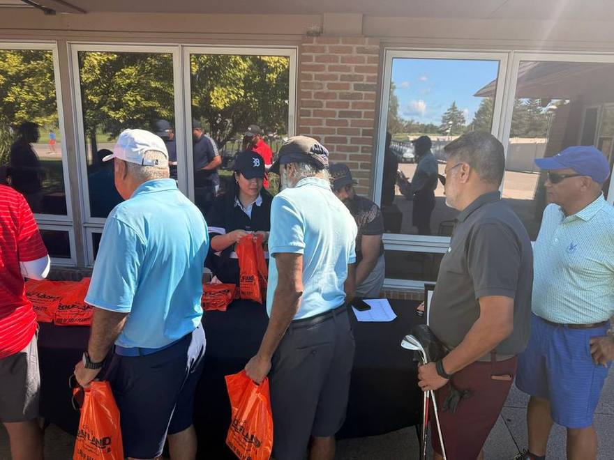 Golfers checking in at the registration table outside the clubhouse